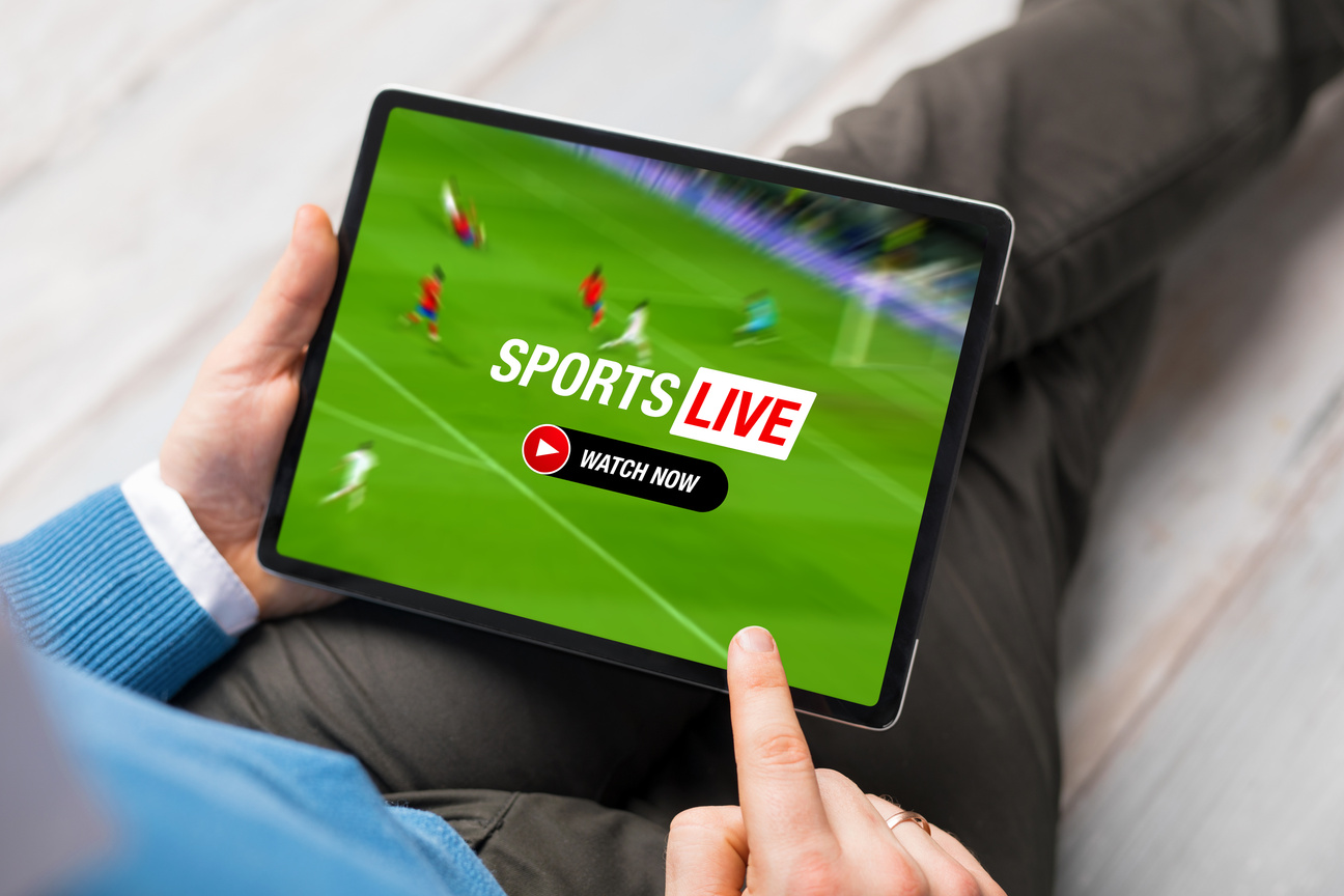 Man watching live stream of football match on tablet